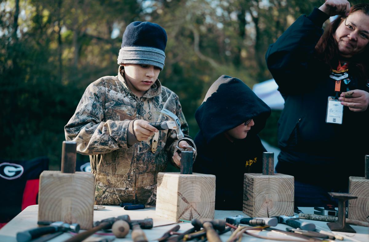 Kids at a metalworking class at a past Georgia Bushcraft event