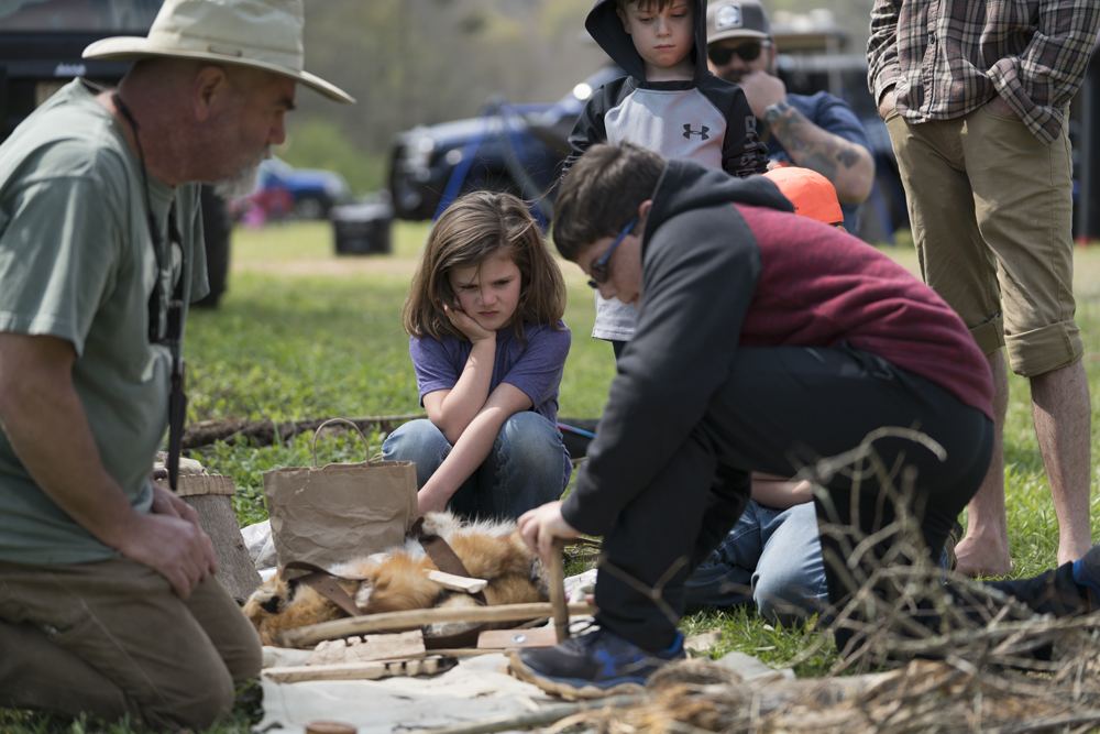 Kids building a fire at a past Gathering