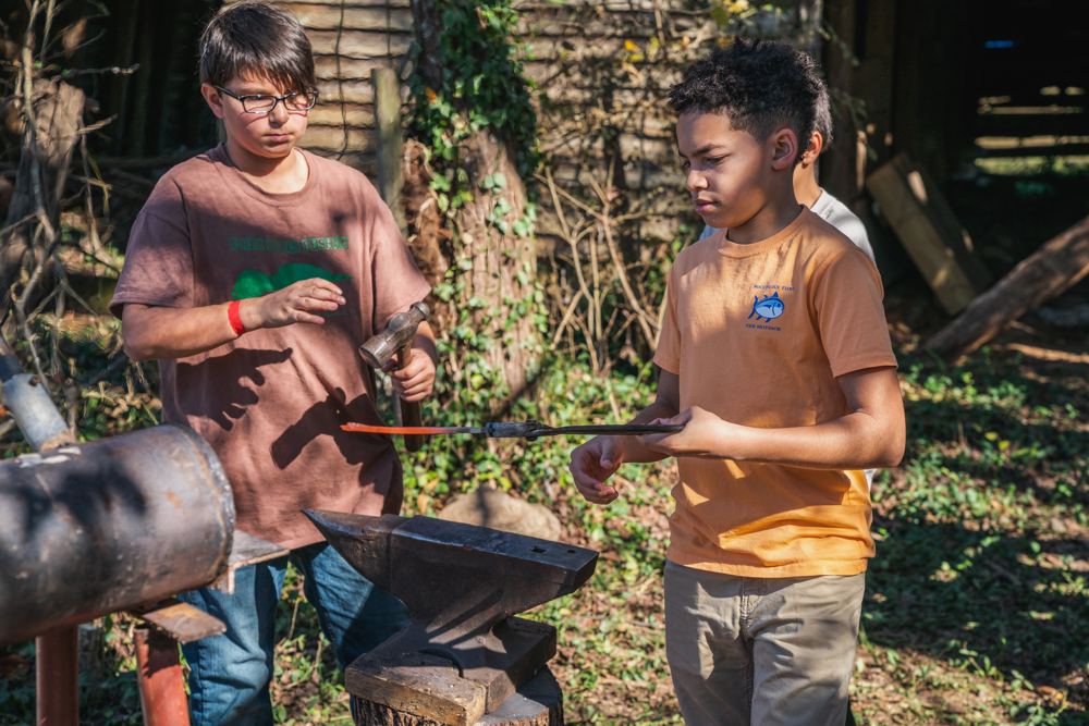 Kids at a blacksmithing class at a past Gathering