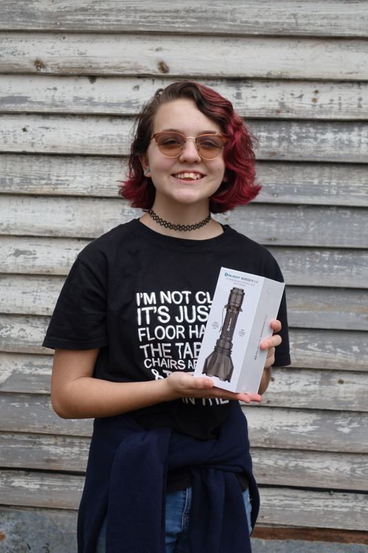 A young bushcrafter holding new gear at a past Gathering