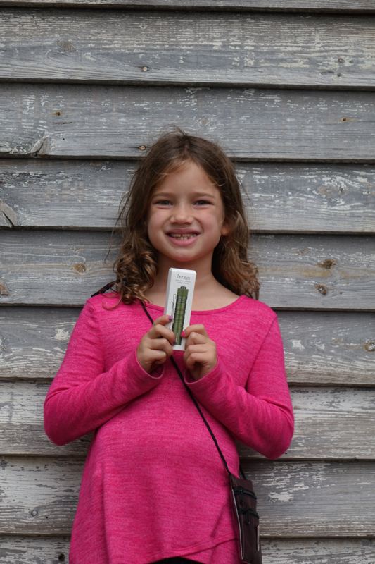 A young bushcrafter holding new gear at a past Gathering